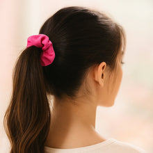 A pack of multi-coloured and textured soft elastic hair scrunchies, highlighting their variety and quality.