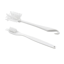 Cleaning brush with ergonomic handle on plain background