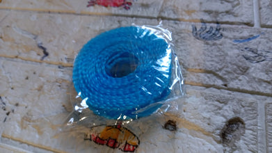 Organivo branded anti-slip clothesline rope set up indoors for laundry drying.