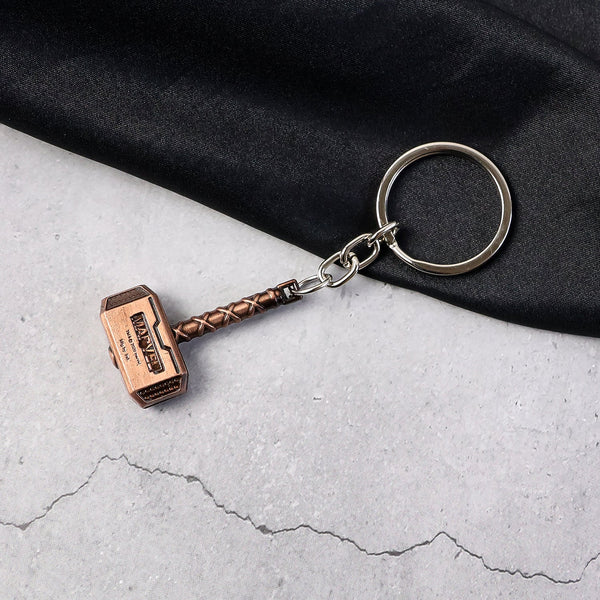 Metal Hammer Keychain with antique bronze finish on neutral background