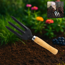 A black three-tine garden fork with a wooden handle lies on dark soil, with a small inset showing it being used.