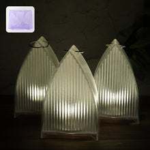 Set of three flameless LED lantern lights with frosted ribbed design emitting warm glow