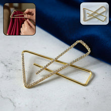 Golden crystal triangle saree safety pin brooch holding fabric securely