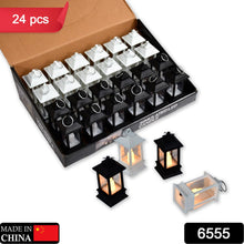 A cardboard box filled with twenty-four miniature black and white LED candle lanterns, with three loose lanterns beside it.