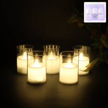 Set of 6 flameless LED votive candles glowing warm inside clear cups
