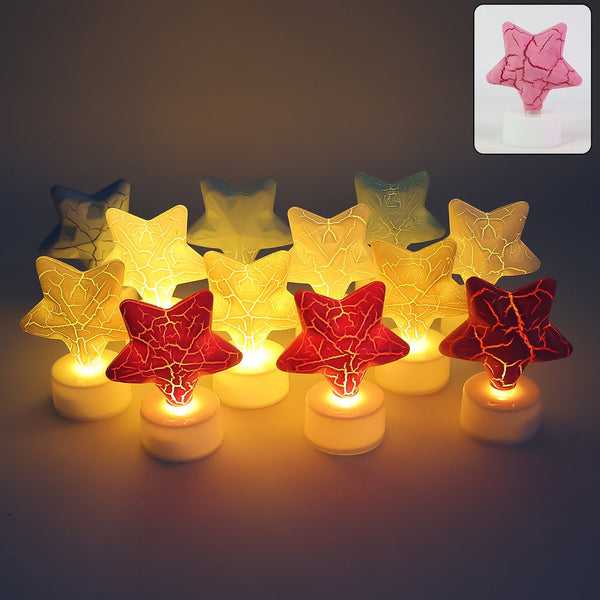 A group of twelve star-shaped LED tealight candles in red, yellow, and blue, glowing warmly in a dim setting.