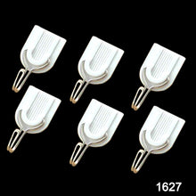Close-up of a white plastic self-adhesive hook on a wall.