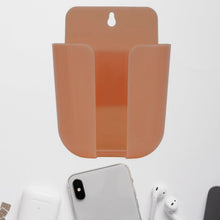 Wall mounted phone holder with a charging port in a modern living space.