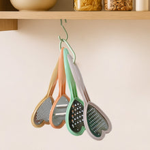 A hand using the heart-shaped grater to effortlessly grate cheese, showcasing its ease of use.