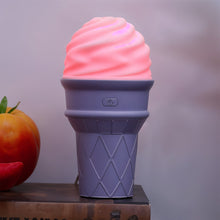 Purple ice cream humidifier emitting mist on table