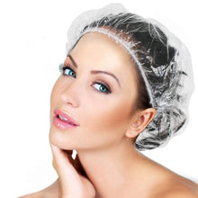 A woman with blue eyes wearing a clear shower cap, looking over her shoulder.