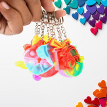Several Pop It Keychains laid out, showcasing their bright colours and unique designs.