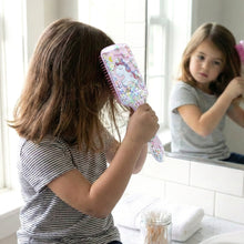 Children's hair care brush with comfortable handle