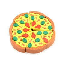 A child's hand holding a bright pizza slice eraser, ready for schoolwork.