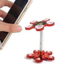 A hand holds a phone next to a red flower-shaped phone holder with a flexible silver arm and 'VIP' text.