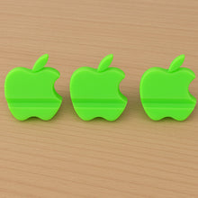 Assorted color apple-shaped mobile phone stands displayed together