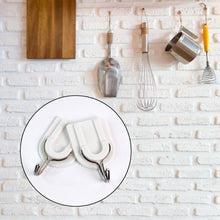 Close-up of a sturdy adhesive wall hook applied to a smooth ceramic tile surface.