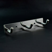 Polished metallic 3 hook rack mounted on bedroom wall