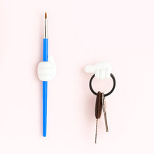 White multifunctional hand-shaped wall clip organizing various small items