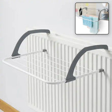 White and gray clothes drying rack hanging on a white radiator, with an inset image showing towels hanging on it.