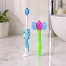 Kids' manual toothbrush and toy hammer on white surface