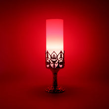 Close-up of LED candle lamp with elegant golden stand and cylindrical candle light