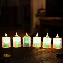 Close-up of a glowing flameless LED tea light candle in a festive setting.