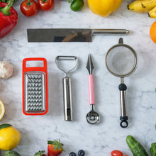 5-in-1 kitchen tool set with chopper, grater, peeler, fruit scoop, and fine mesh strainer