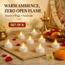 Eight lit LED tealight candles arranged on a golden mat, surrounded by flower petals and religious items.