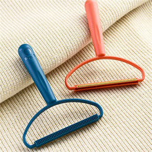 The versatile lint remover effectively cleaning lint and debris from a carpet surface using its copper blade.