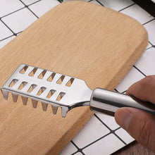 Fish scale remover scraper in action, demonstrating easy scale removal.