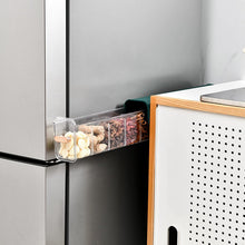 Wall mount drawer organizer attached to a bathroom wall, storing small toiletries.