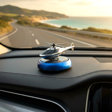 Decorative helicopter fragrance diffuser placed on car dashboard