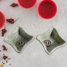 Close-up of a durable ceramic tea cup and plastic snack bowl from the 4-piece set.