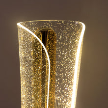 Close-up of the top of the lit gold and clear crystal table lamp, showing the sparkling texture.
