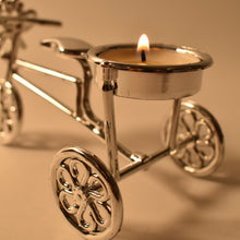 Close-up of tealight candle burning on decorative cycle stand holder