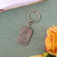 Detailed view of the Ganesh cut-out on the metal keychain, highlighting its fine craftsmanship.