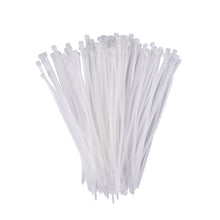 A hand holding flexible black self-locking cable ties, demonstrating their durability.