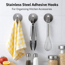 Multiple self-adhesive wall hooks holding various items in an organized display.