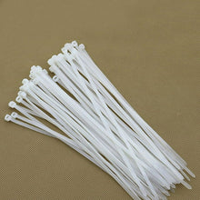 A large stack of white cable ties arranged neatly on a textured brown surface.
