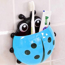 Ladybug Toothbrush Holder holding several toothbrushes, demonstrating its family-friendly capacity.
