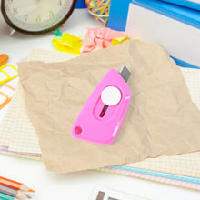 Mini Cloud Cutter utility knife being used to cut a plastic bag smoothly