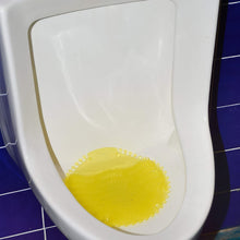 Urinal screen deodorizer mat placed inside urinal for splash control and odor freshness.