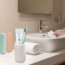 Blue travel toothbrush holder securely containing a toothbrush and toothpaste.