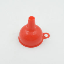 Silicone funnel in action, efficiently pouring oil into a bottle.