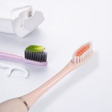 BrushedUp Electric Toothbrush held by a hand, demonstrating its lightweight and comfortable grip.