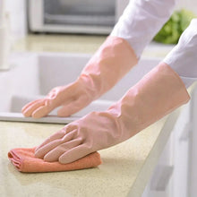 Durable natural gum rubber gloves protecting hands while cleaning a kitchen sink.