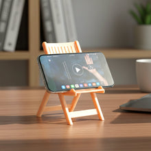 Mini chair shaped mobile stand holder in peach color placed on a table