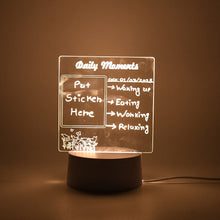 A softly glowing acrylic message board lamp on a dark surface, displaying a daily schedule.