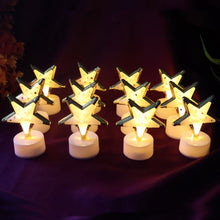 Twelve glowing star-shaped LED candles with gold frames and white bases arranged on a rich purple fabric.